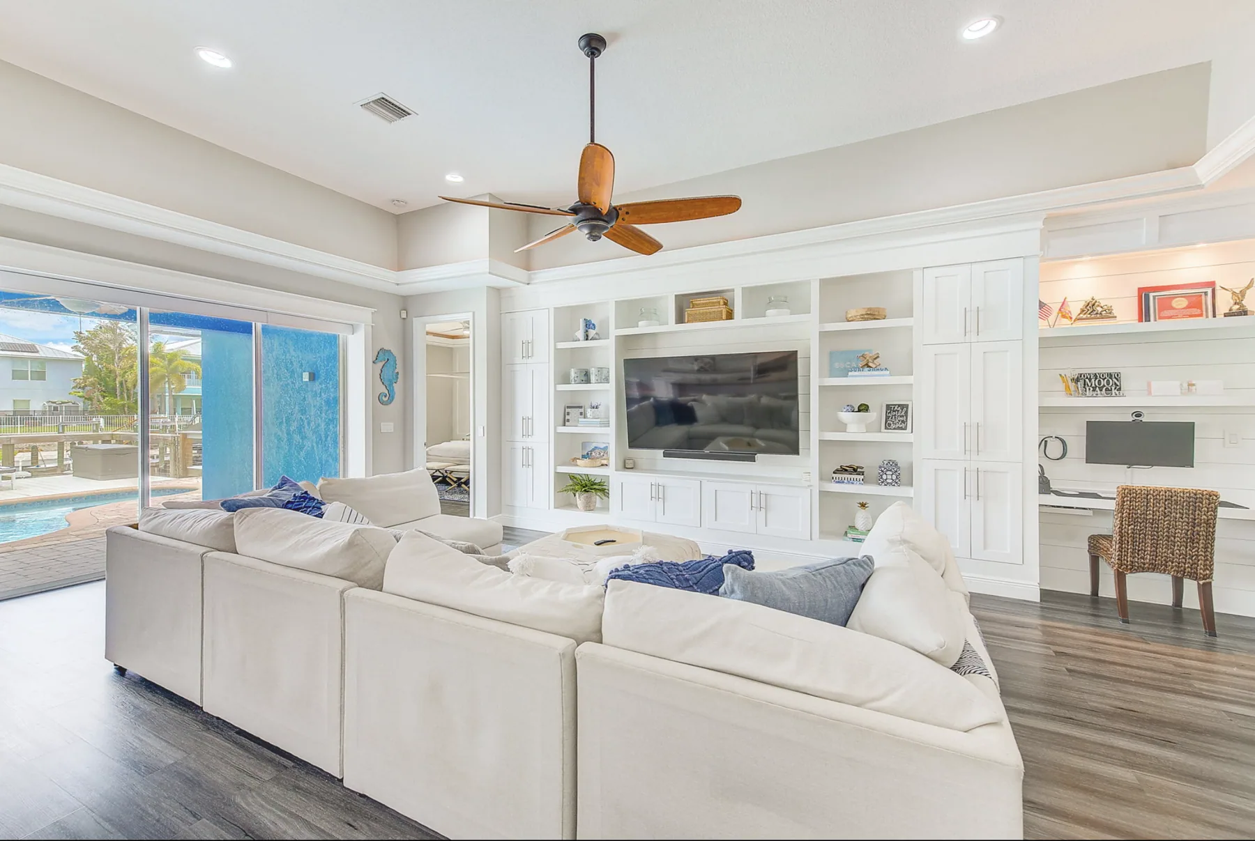 The Isla Residence living room with custom cabinetry and coastal interiors