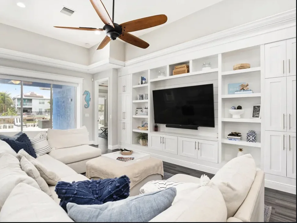 The Isla Residence living room with custom cabinetry and coastal interiors